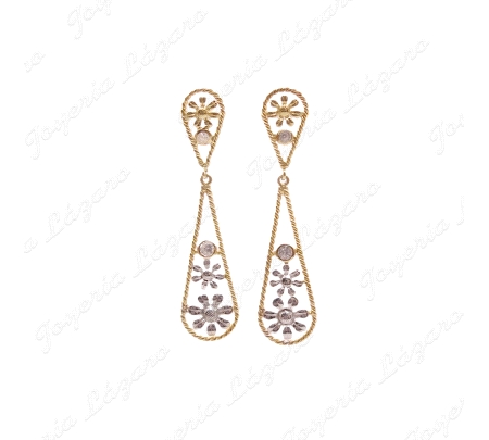 PEND. LARGOS ORO 18 KTS BIC. GOTA CALADA CON FLORES BLANCAS DENTRO